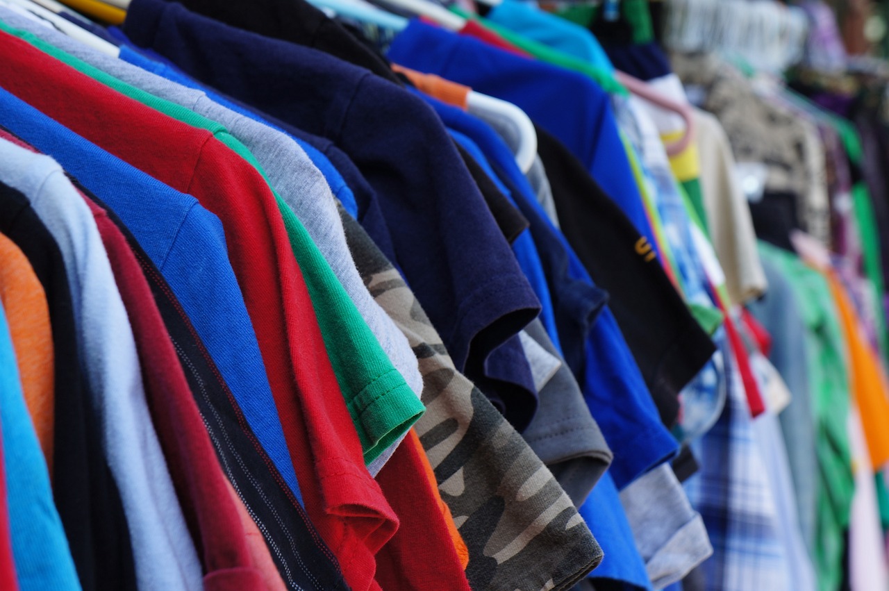 colourful t shirts and other clothing on hangers